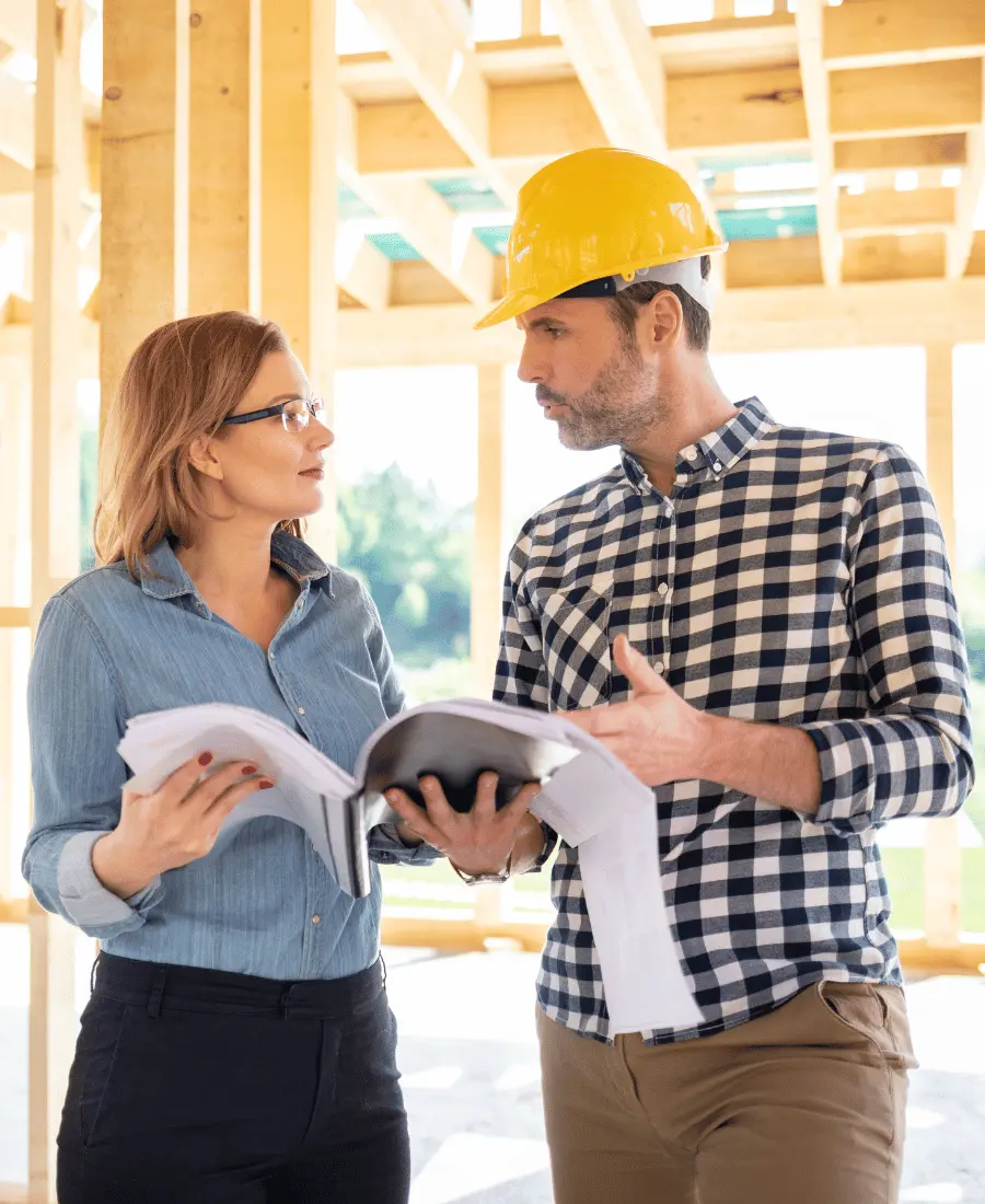 Two builders on construction site talking