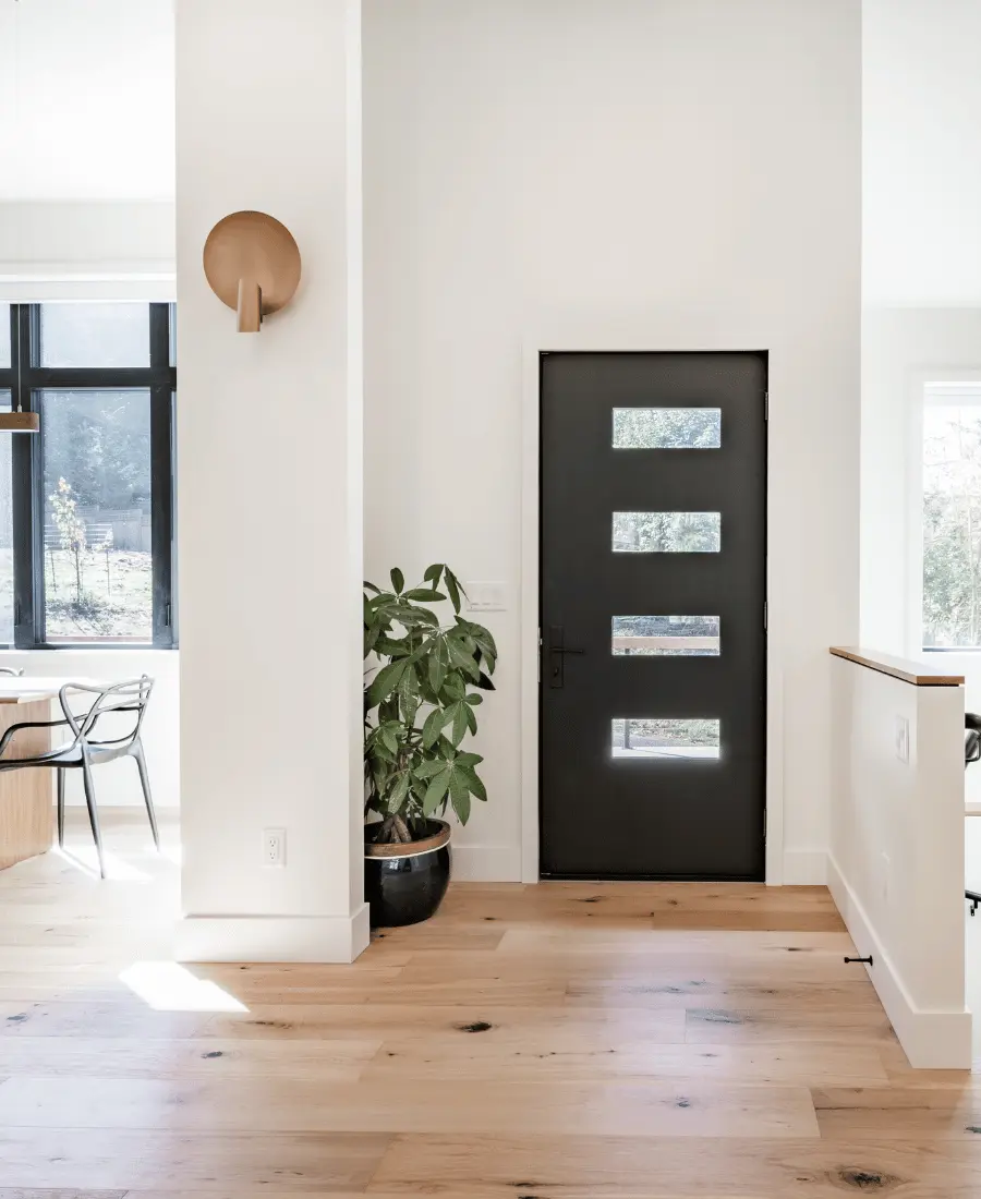 Modern interior. Front door with stairwell to the right and dining area to the left