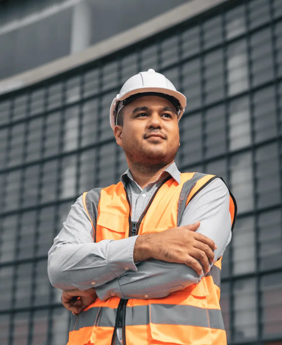 Happy builder smiling with arms crossed