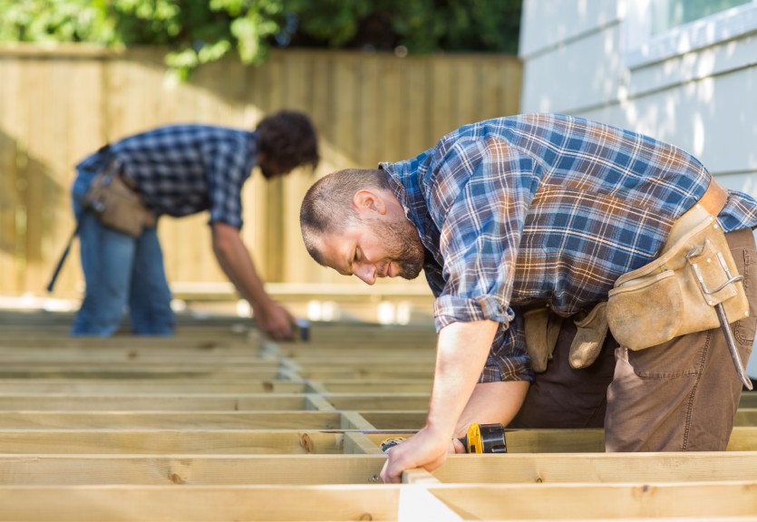 Two builders working on pergola