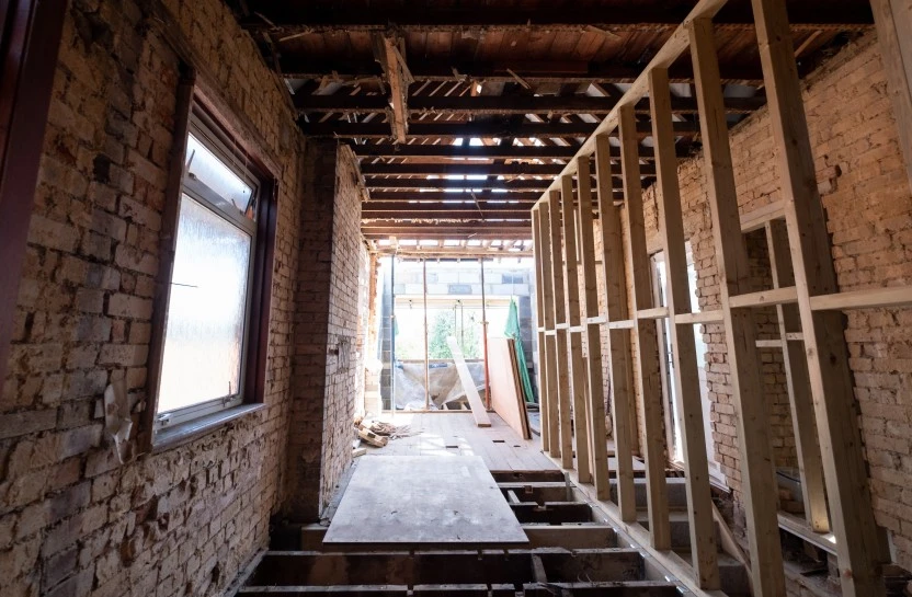 Building site, inside room with bricks and wooden frame